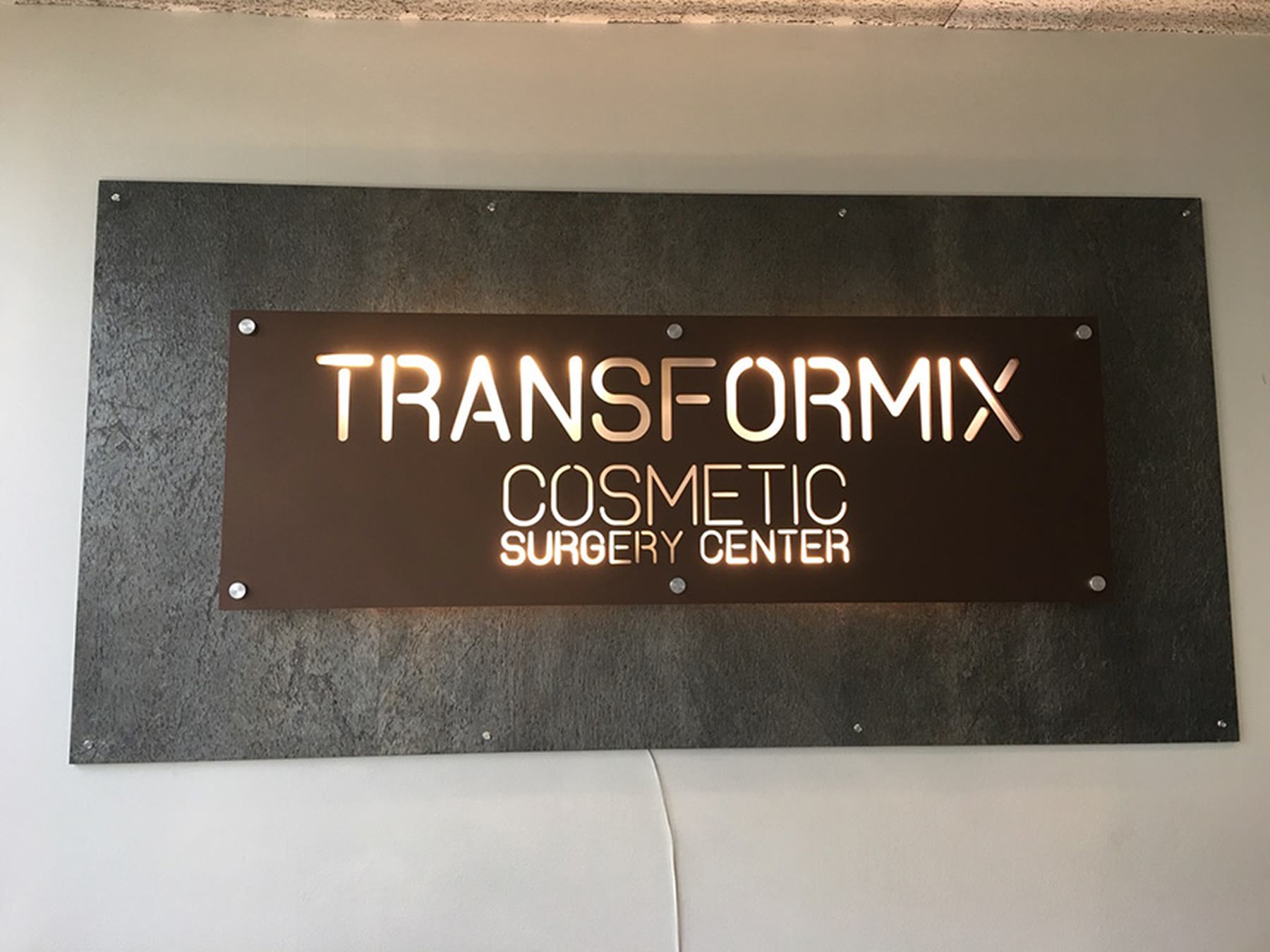 Metal sign for a cosmetic surgery center